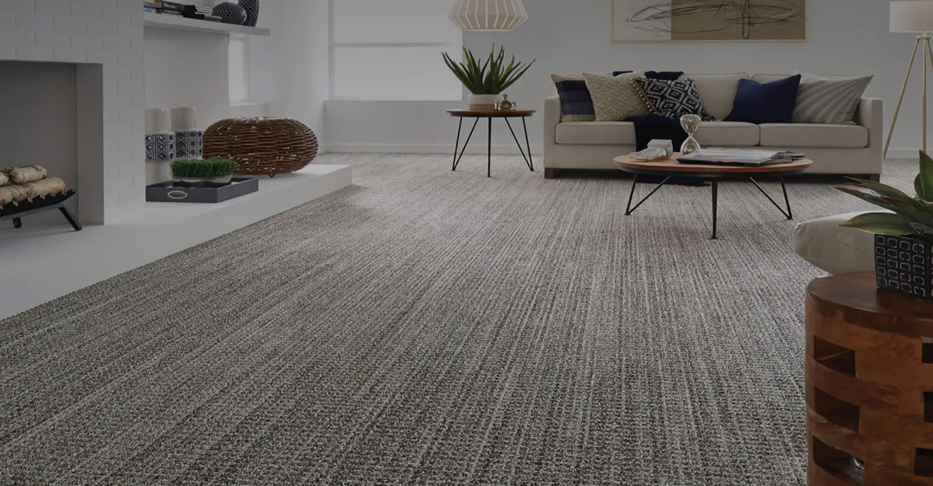 Woman sitting on a hardwood floor with a coffee mug in her hand.