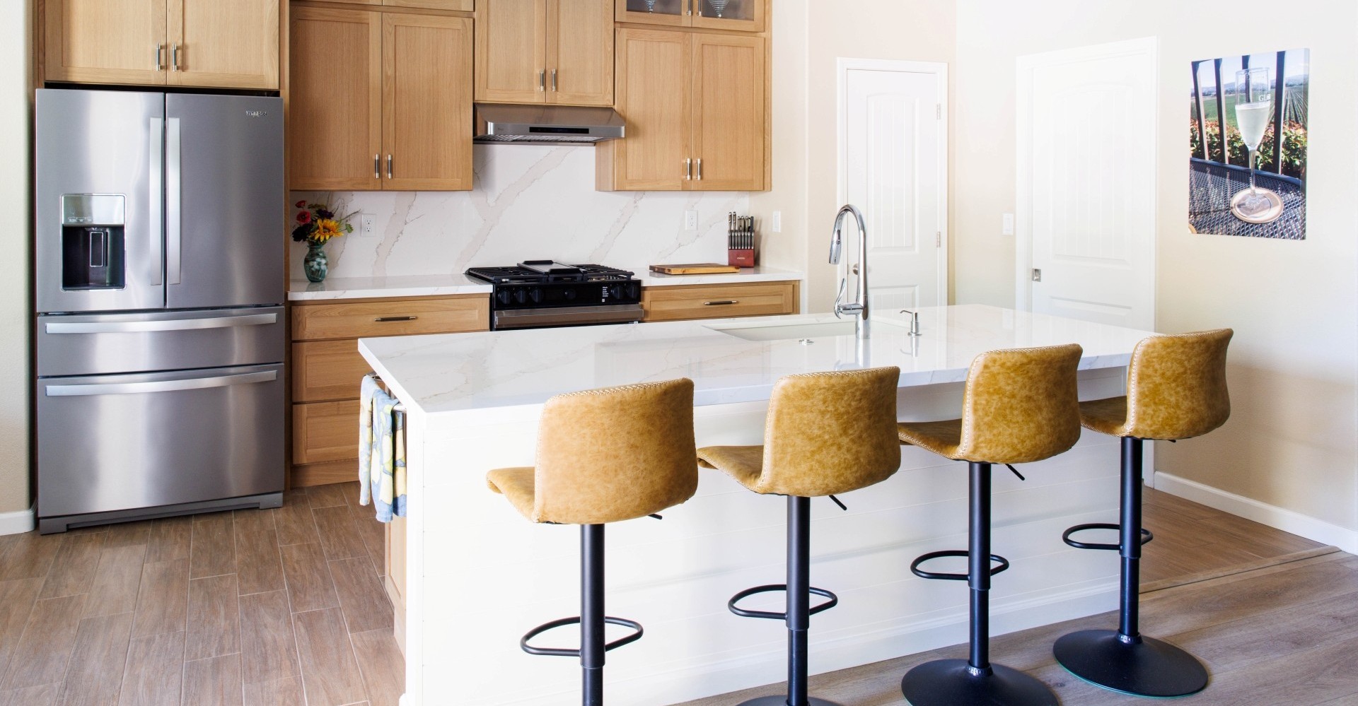 Woman sitting on a hardwood floor with a coffee mug in her hand.