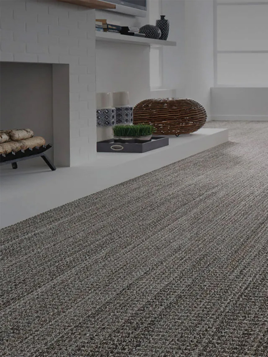 Woman sitting on a hardwood floor with a coffee mug in her hand.